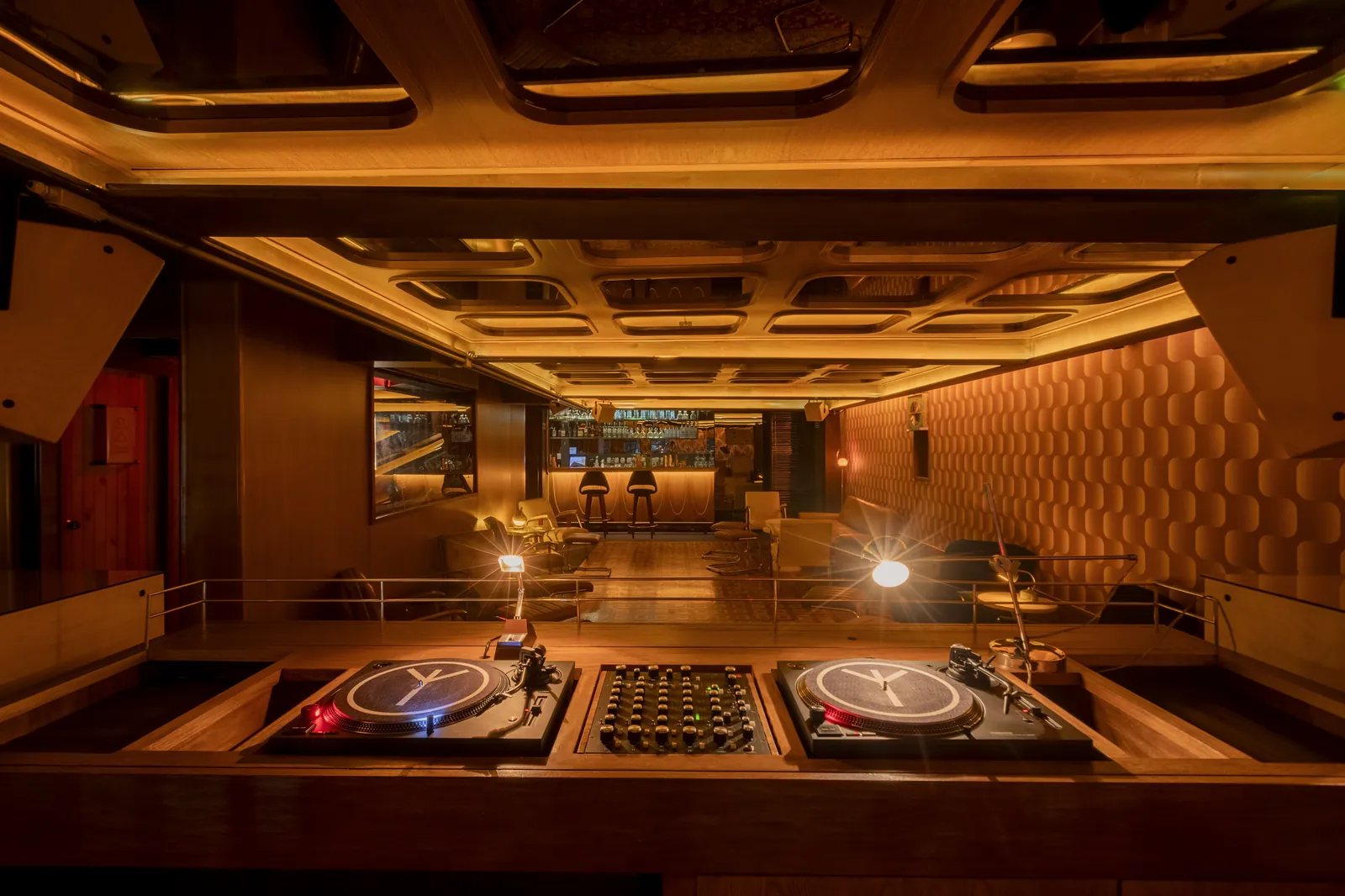 Collector's Lounge: cabina de DJ con tornamesas de vinilo y el lounge de fondo